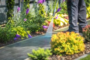 House exterior cleaning concept, professional performing pressure washing.